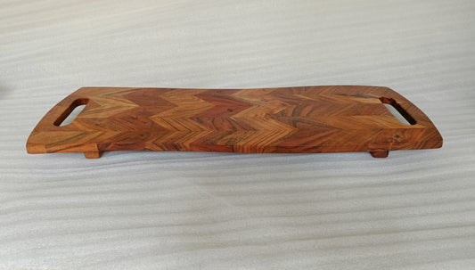 ACACIA WOOD 28" X 10" CHEVRON CUTTING BOARD WITH FEET